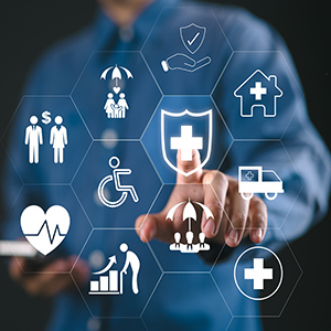 Person touches a digital healthcare shield surrounded by insurance and medical icons.